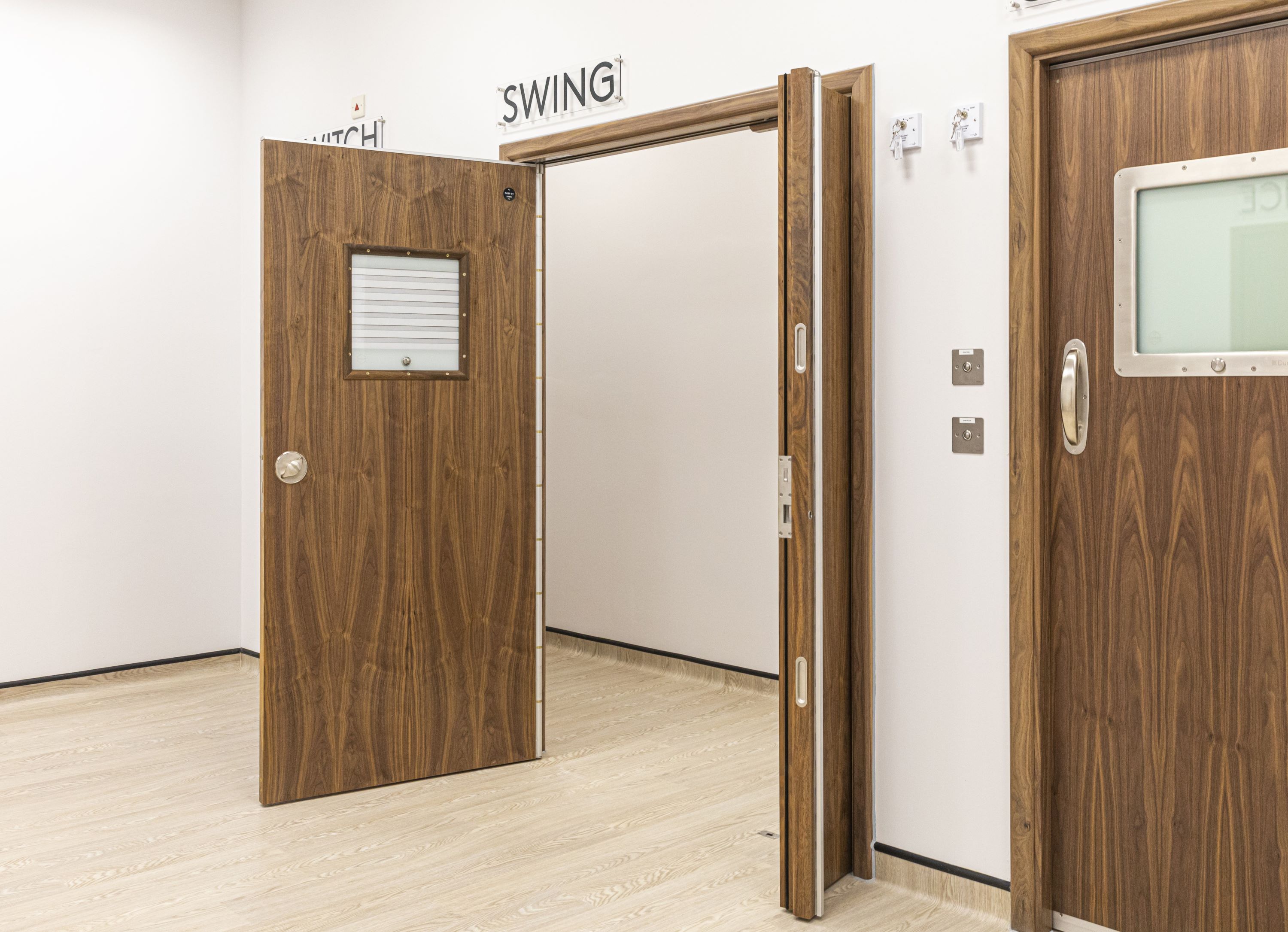 SWING Anti-Barricade Door System with leaf and half leaf open for wide access.