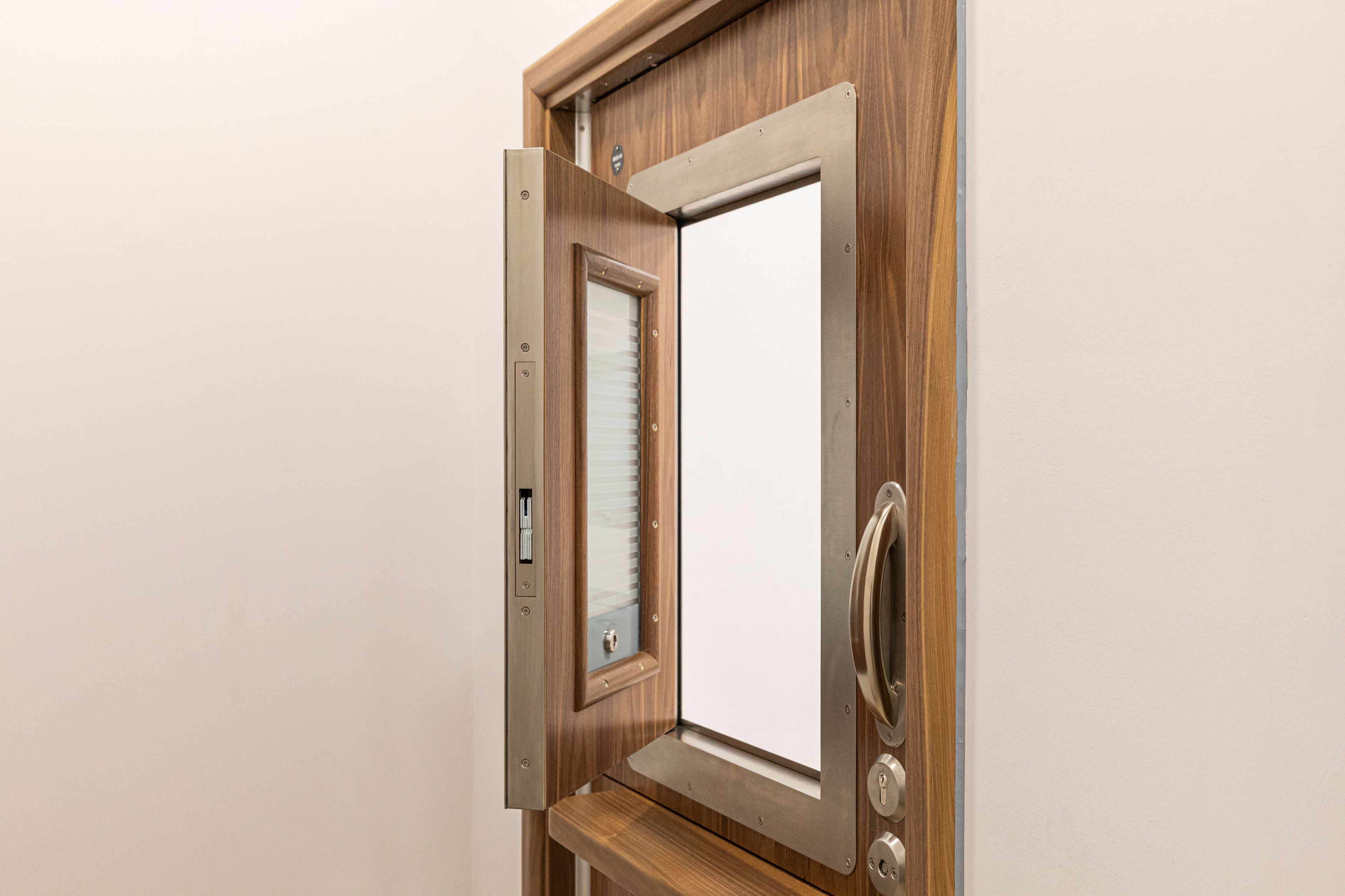 STABLE Split Leaf Door System with clinic room hatch and vision panel.