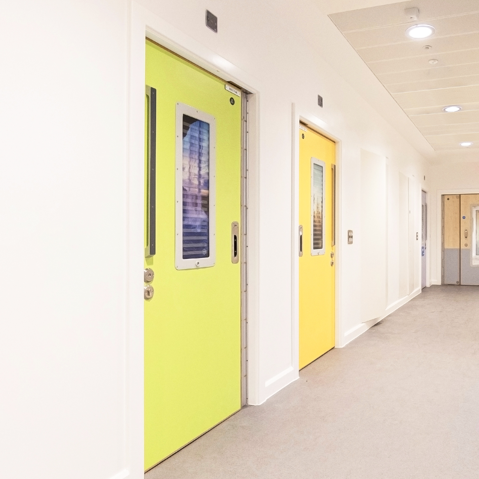 Kingsway Group's SWITCH Anti-Barricade Complete Door System in use within a mental health facility, customised with a coloured finish to the door leaf and bespoke imagery on the privacy Vision Panel.